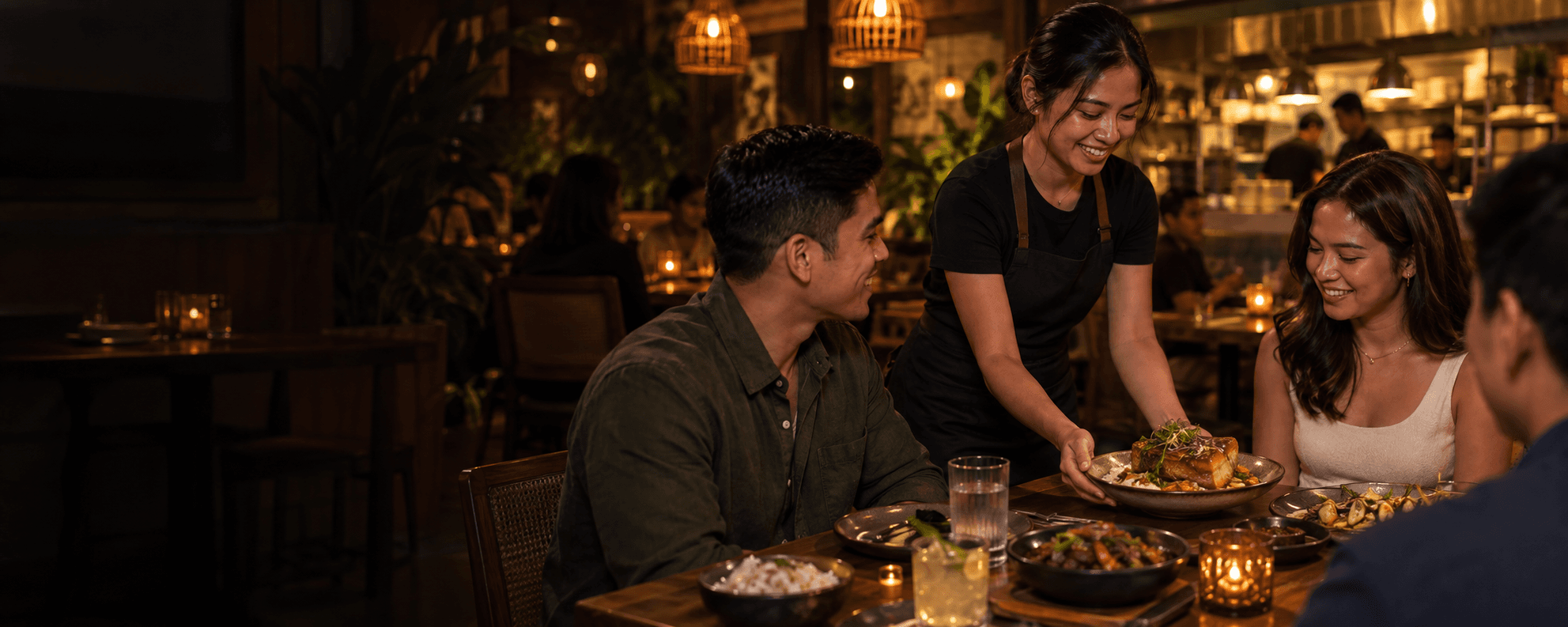 A server bringing a meal to guests at a restaurant table